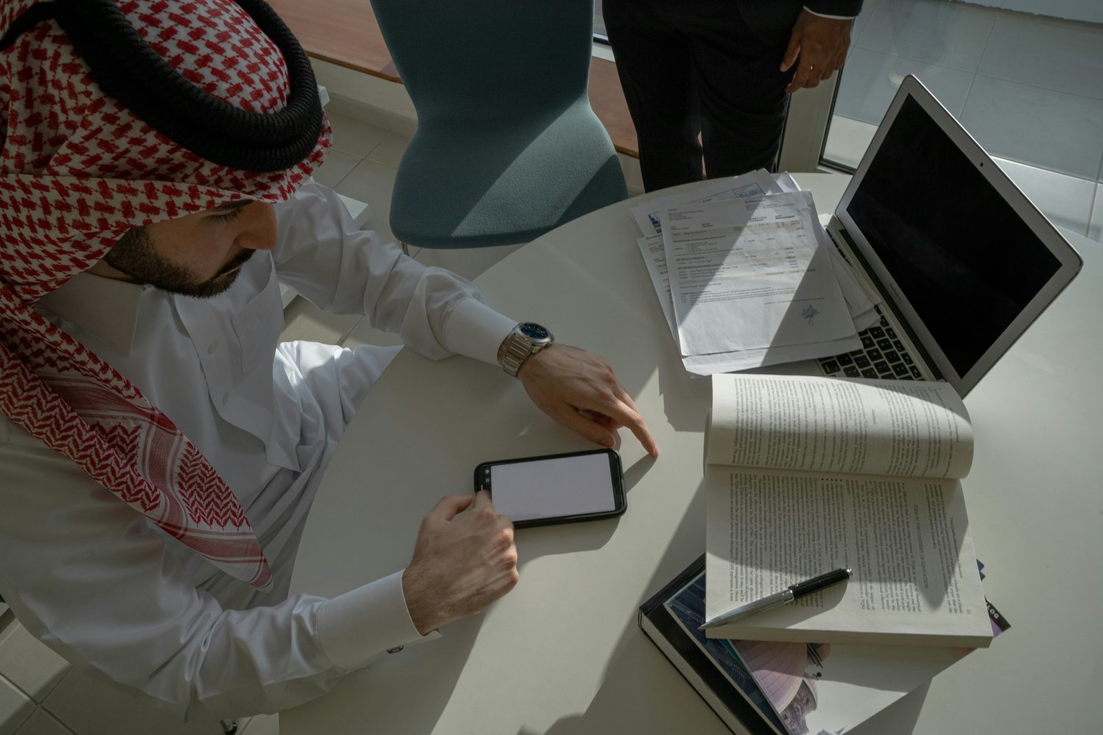 Saudi professional consultant at desk